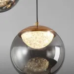 Серия подвесных светильников с LED-источниками света в полусферических рассеивателях с эффектом льда внутри шарообразных плафонов из тонированного стекла MAYER ORB L9 от ImperiumLoft