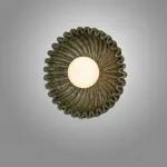 Серия настенных светильников с вогнутым рельефным корпусом из керамики и шарообразным плафоном в центре STEVEN Green от ImperiumLoft