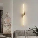 Серия настенных светодиодных светильников в виде композиции разноуровневых светящихся и металлических стержней TINUS BEND H105 Brass от ImperiumLoft