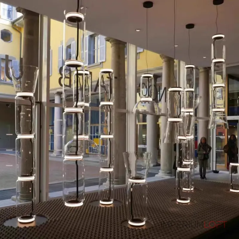 Серия подвесных светильников из прозрачных стеклянных скругленных цилиндров c LED подсветкой сверху и снизу QUENTIN A H128 от ImperiumLoft