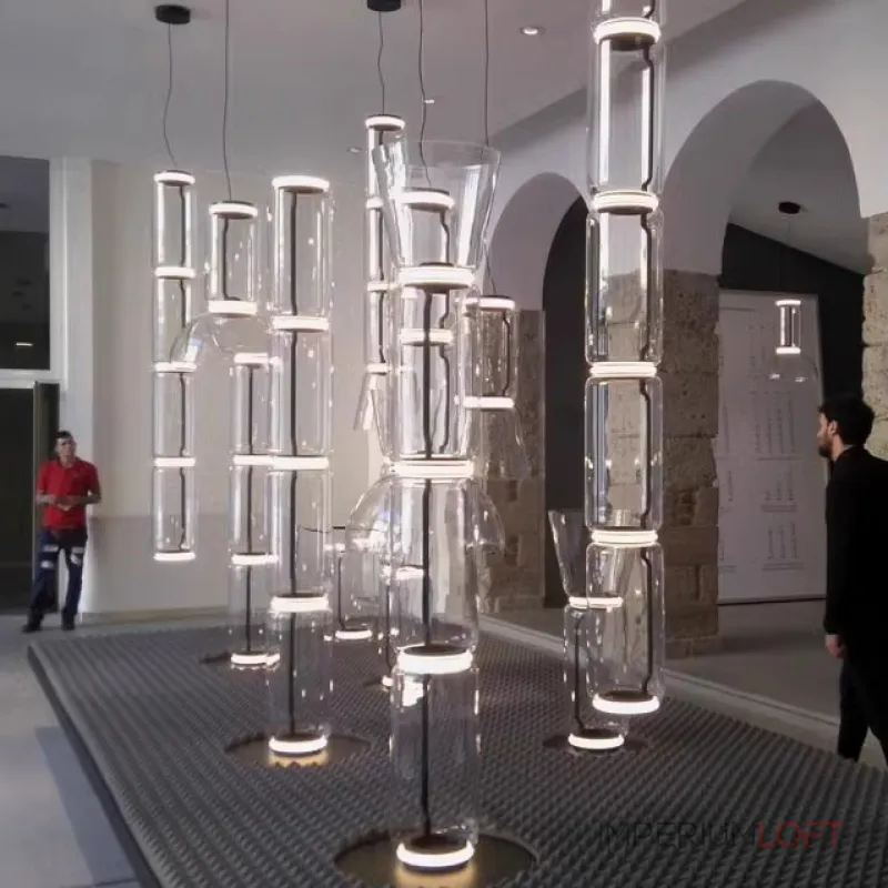 Серия подвесных светильников из прозрачных стеклянных скругленных цилиндров c LED подсветкой сверху и снизу QUENTIN A H128 от ImperiumLoft