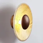 Настенный светодиодный светильник в виде вогнутого диска из натурального травертина от ImperiumLoft