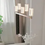 Серия рядных светильников с плафонами вогнутой цилиндрической формы на разноуровневых вертикальных стойках GISSEL A от ImperiumLoft