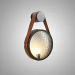 Серия настенных светильников с рельефным стеклянным плафоном в форме линзы на кожаном ремешке ODMAR Brown ImperiumLoft