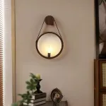 Серия настенных светильников с рельефным стеклянным плафоном в форме линзы на кожаном ремешке ODMAR Brown ImperiumLoft