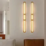 Серия светодиодных настенных светильников с удлиненным цилиндрическим плафоном и антибликовой решеткой по бокам Бра ERKER WALL H60 Brass от ImperiumLoft