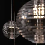 Каскадный светильник с комбинацией из 30-ти стеклянных подвесов в форме призм и сфер с концентрическим рельефом STYRK COMBO от ImperiumLoft